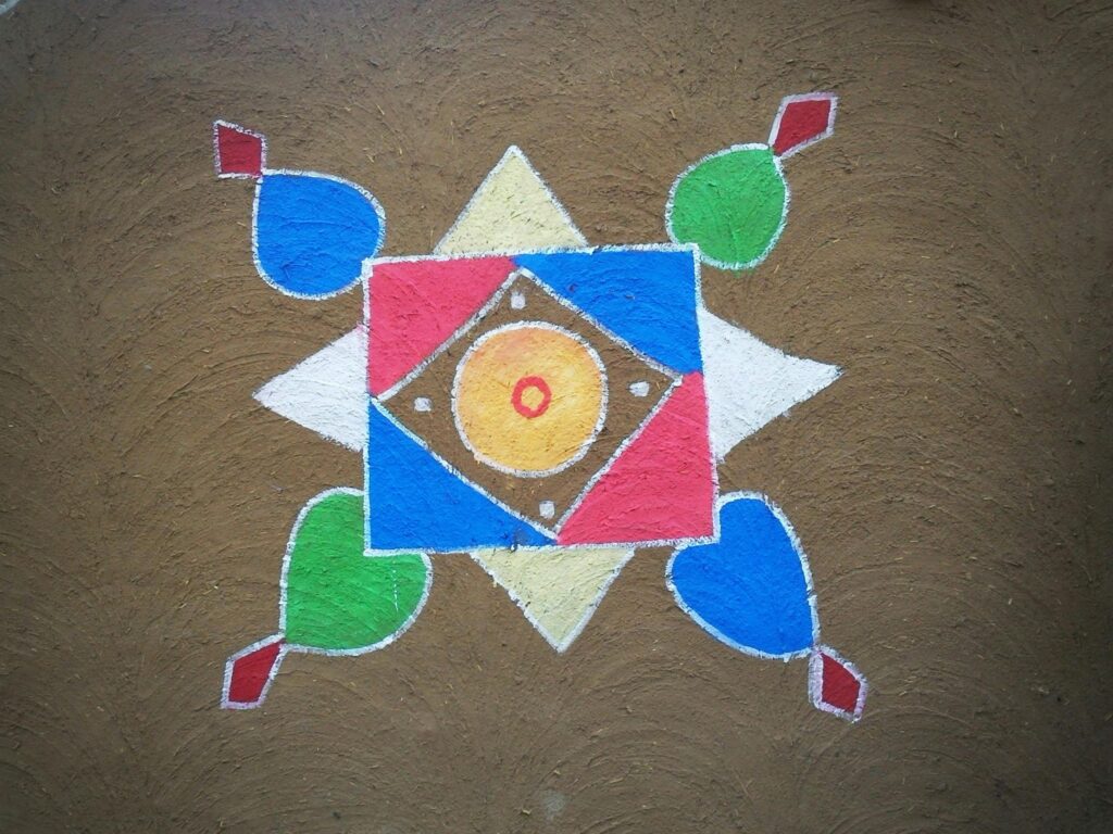 Vibrant geometric rangoli design on brown textured surface, showcasing Indian folk art and cultural heritage.